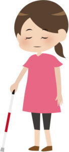 白杖をついて立っている視覚障害者の女性