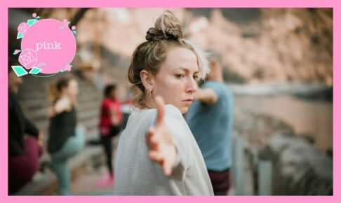 数人でヨガのポーズをしている中、髪の毛をお団子結びにしている女性