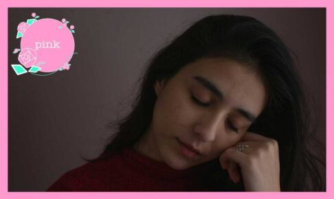 目を閉じて、握りしめた左手に頬をあずけている女性