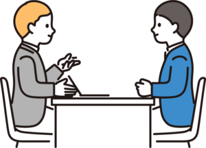 向き合って打ち合わせをする男性二人