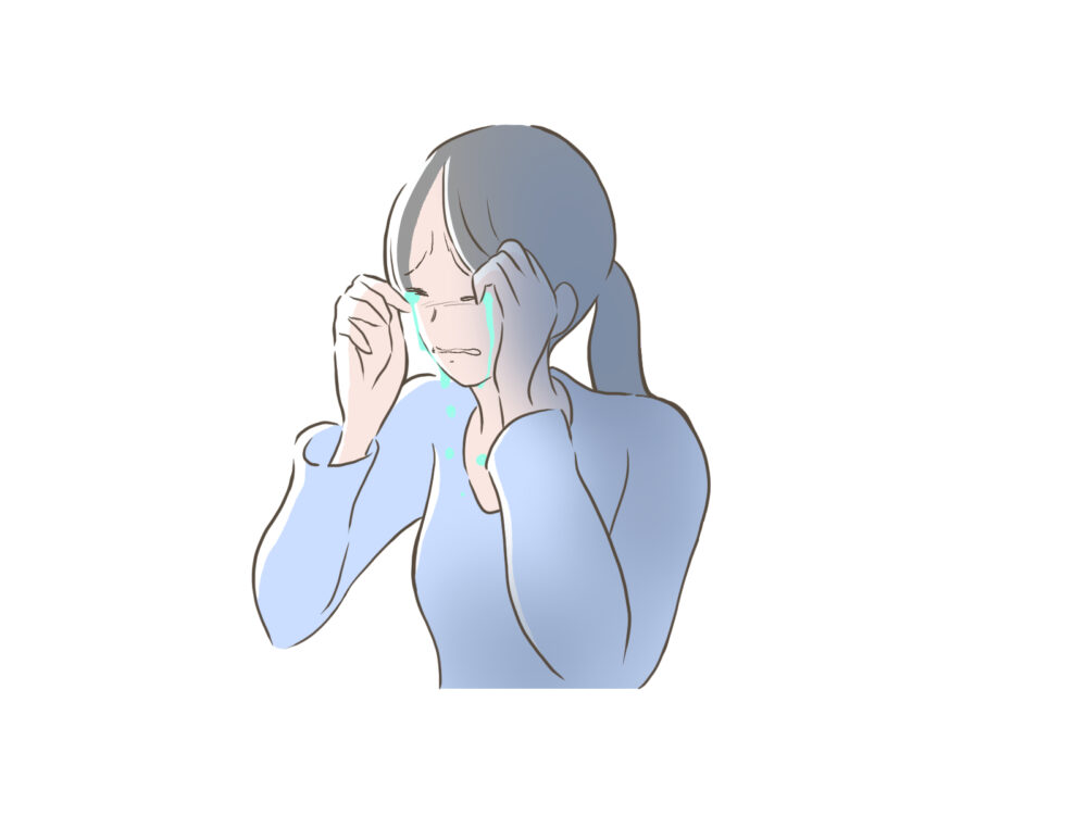 辛そうに涙を流す女性