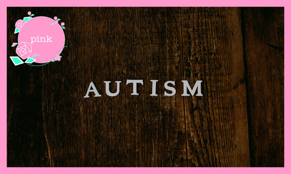 白いアルファベット文字で自閉症と書かれた茶色の木の壁