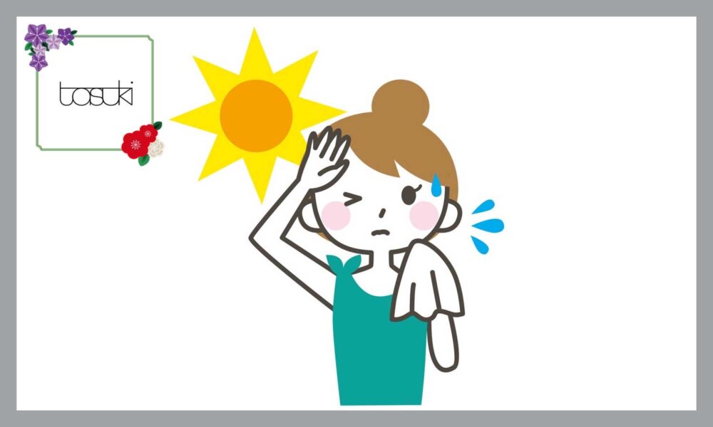 汗をタオルで拭く女性