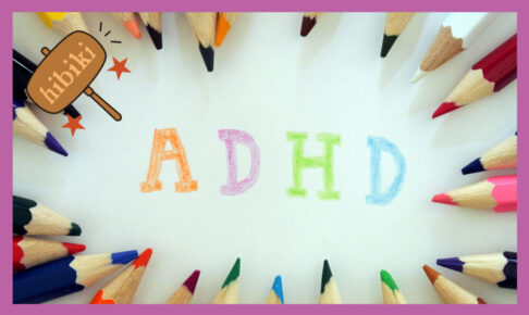 色鉛筆が並べてあり、その中で、英語で「ADHD]と色鮮やかに表現してある。